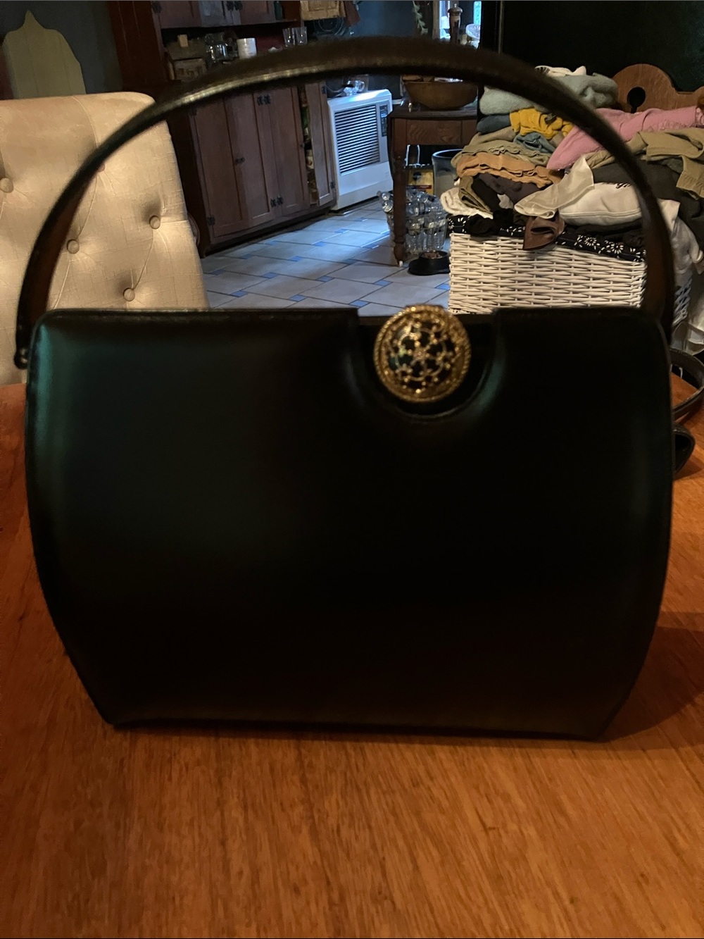Black Top-Handle Satchel with Decorative Gold Emblem